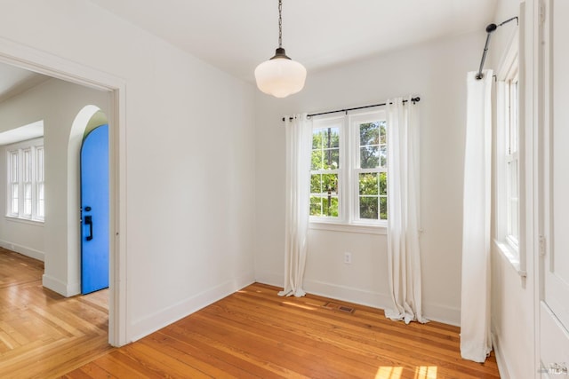 331 1st St, Healdsburg, CA 95448 - spare room with baseboards, arched walkways, visible vents, and light wood-style floors