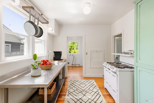 331 1st St, Healdsburg, CA 95448 - kitchen featuring a sink, light wood-style flooring, light countertops, and green cabinets