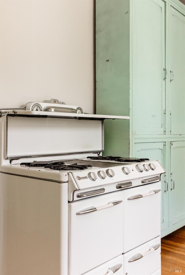 331 1st St, Healdsburg, CA 95448 - interior details featuring green cabinetry, white gas stove, and wood finished floors