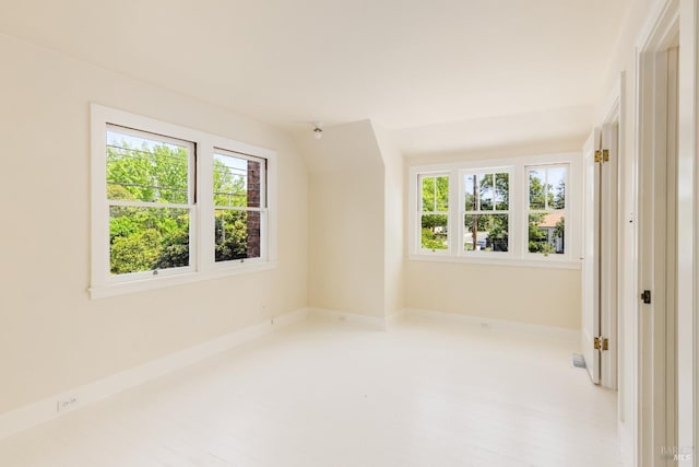 spare room with plenty of natural light and baseboards