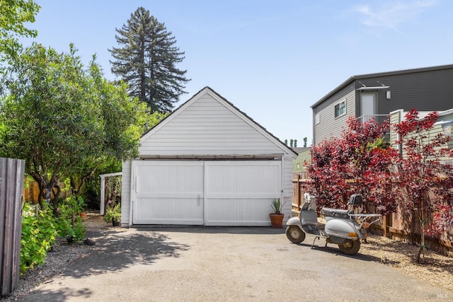detached garage featuring fence