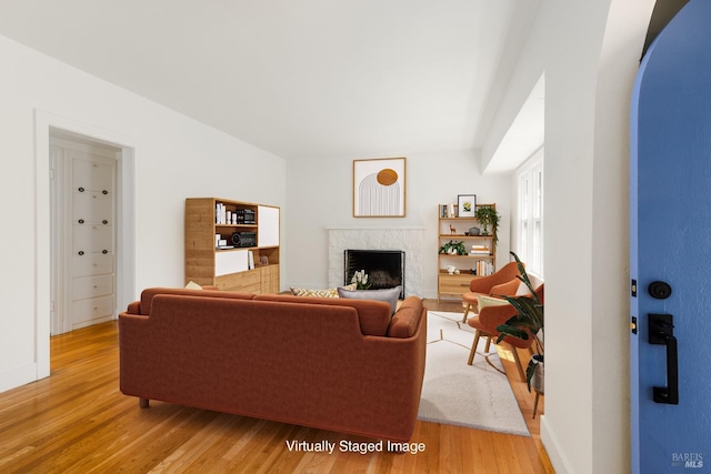 331 1st St, Healdsburg, CA 95448 - living area featuring a fireplace, arched walkways, light wood-type flooring, and baseboards