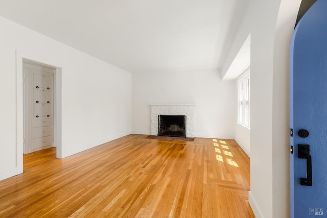 331 1st St, Healdsburg, CA 95448 - unfurnished living room featuring light wood-style floors, a premium fireplace, and arched walkways