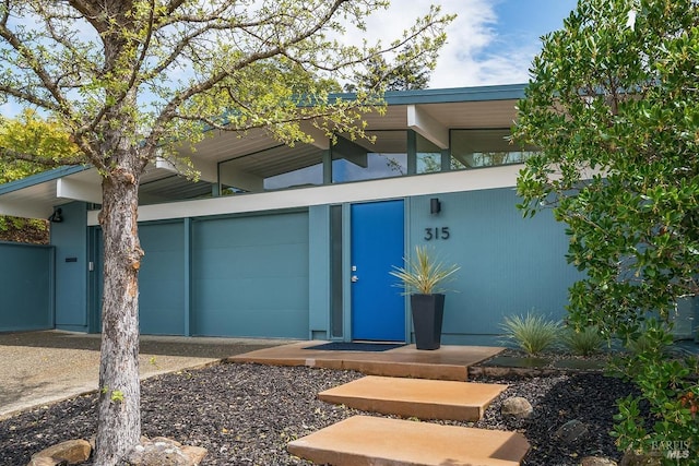 doorway to property with a garage