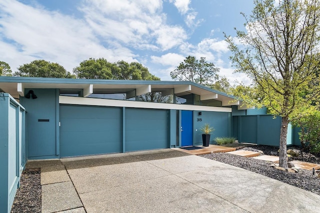exterior space with a garage and concrete driveway