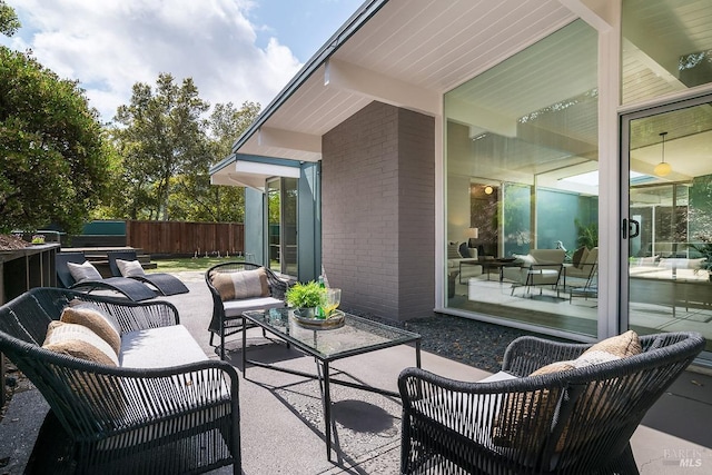 view of patio featuring an outdoor hangout area and fence