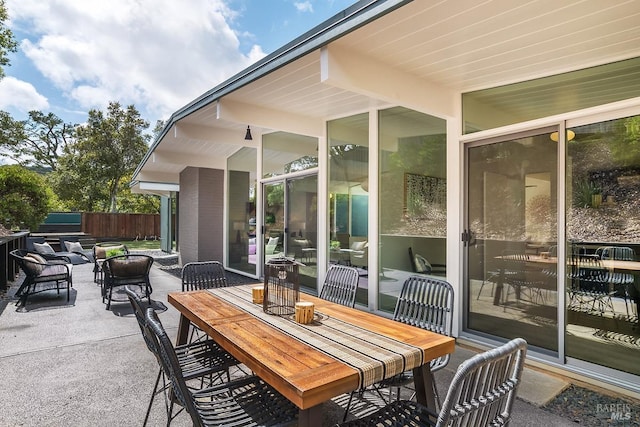 view of patio with outdoor dining space and fence