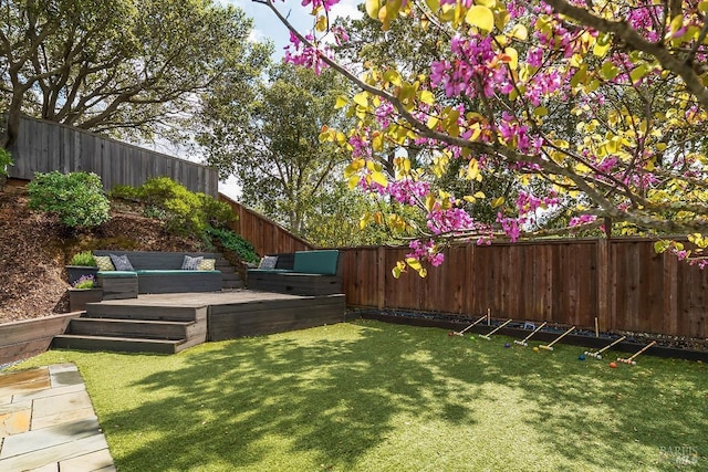 view of yard with a fenced backyard and a deck