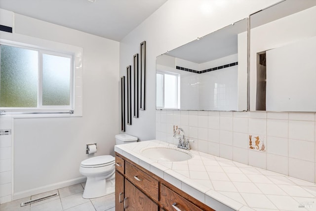 full bath with tile patterned flooring, vanity, toilet, decorative backsplash, and visible vents