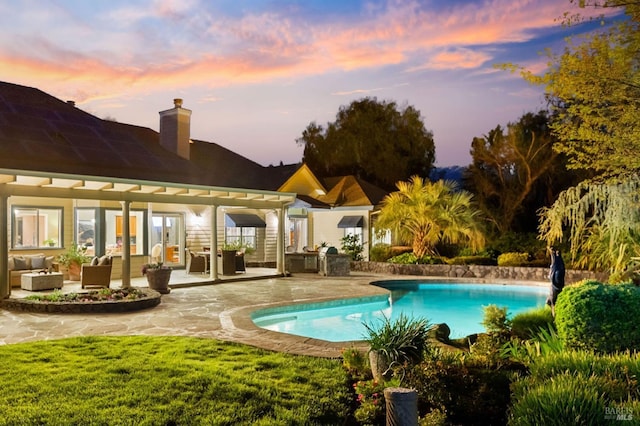 pool with outdoor lounge area and a patio