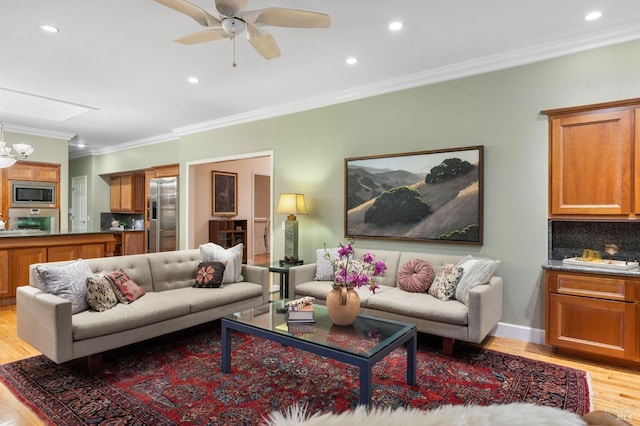 living area with crown molding, light wood-style flooring, and recessed lighting