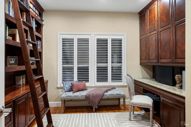 office area with baseboards and wood finished floors