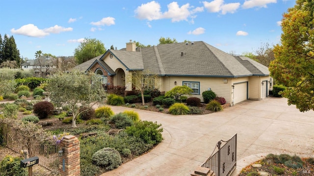 view of front of house featuring a chimney, fence, a garage, and concrete driveway