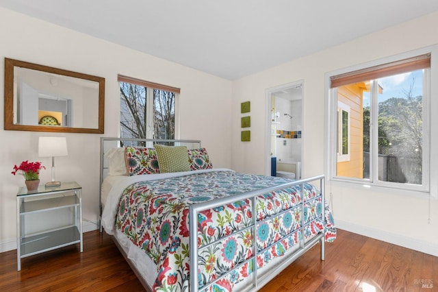 bedroom featuring baseboards and wood finished floors