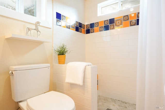 bathroom featuring a walk in shower and toilet
