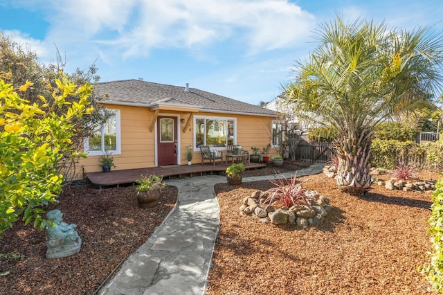 bungalow-style house featuring fence and a wooden deck