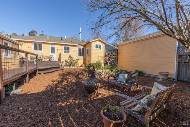 back of house with a deck
