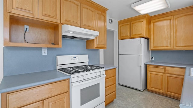 kitchen with light countertops, light brown cabinets, under cabinet range hood, and white appliances