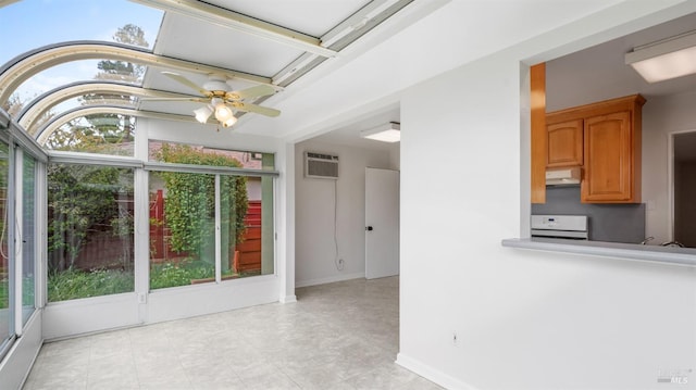 interior space with baseboards, a wall mounted AC, and ceiling fan