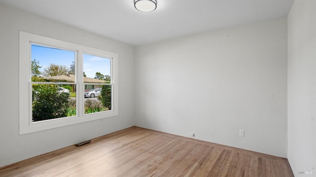 spare room with wood finished floors