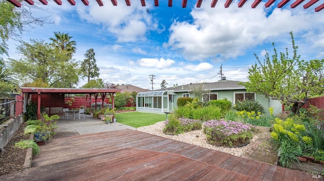 exterior space featuring a sunroom and fence