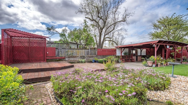 view of yard with a patio area, fence, and a deck