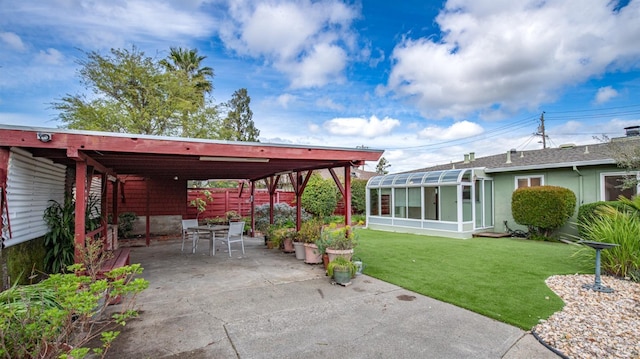 view of patio / terrace featuring outdoor dining area and a sunroom