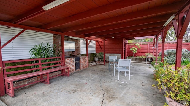 view of patio with fence and outdoor dining space