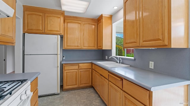 kitchen featuring a sink, freestanding refrigerator, light countertops, ventilation hood, and recessed lighting