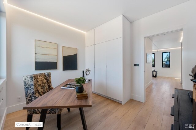 home office with baseboards and light wood-style floors