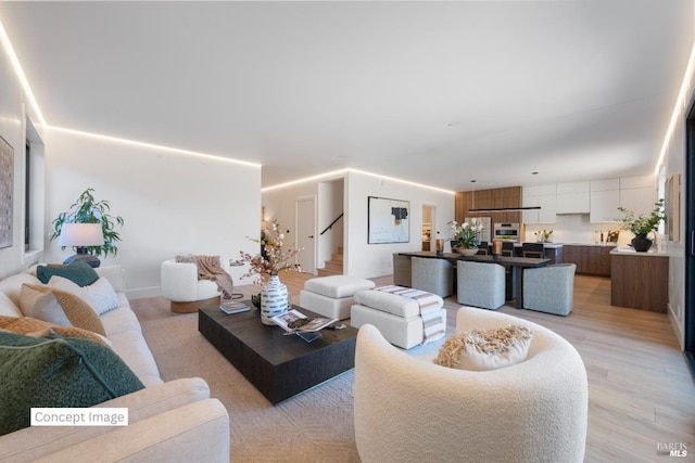 living area featuring stairs and light wood-type flooring
