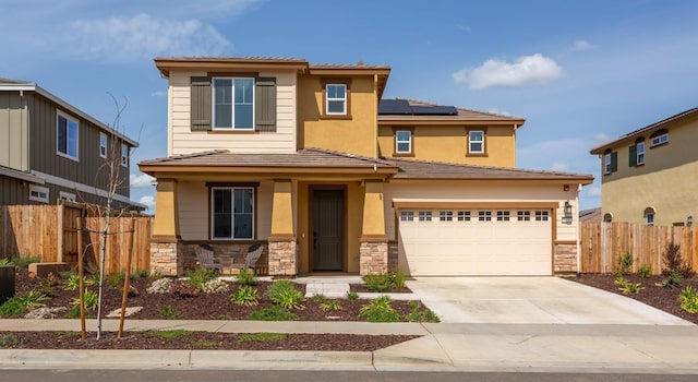 1108 Hiramatsu Ln, Winters, CA 95694 - view of front of home featuring stone siding, roof mounted solar panels, an attached garage, fence, and driveway