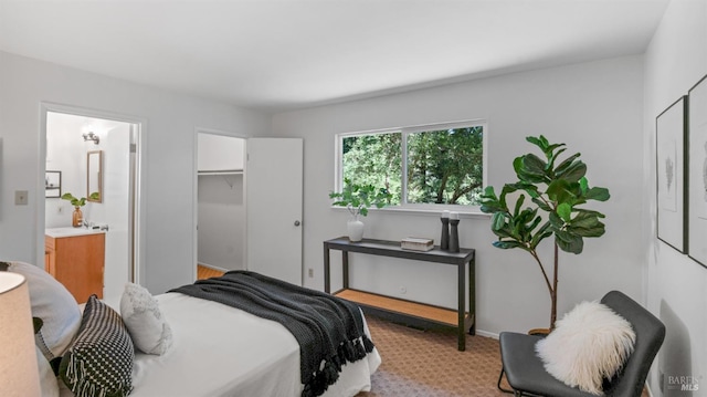 bedroom with light carpet and ensuite bath
