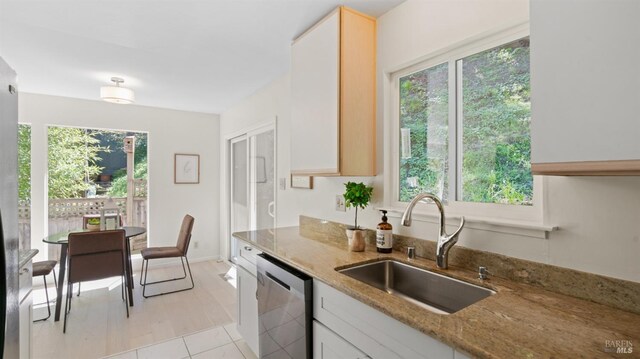 317 Olema Rd, Fairfax, CA 94930 - kitchen with a sink, stainless steel dishwasher, light stone counters, and light tile patterned floors