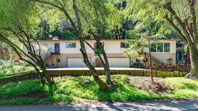 317 Olema Rd, Fairfax, CA 94930 - view of front facade with stairs, an attached garage, and stucco siding