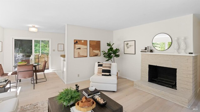 317 Olema Rd, Fairfax, CA 94930 - living area with light wood-type flooring, a fireplace with raised hearth, and baseboards