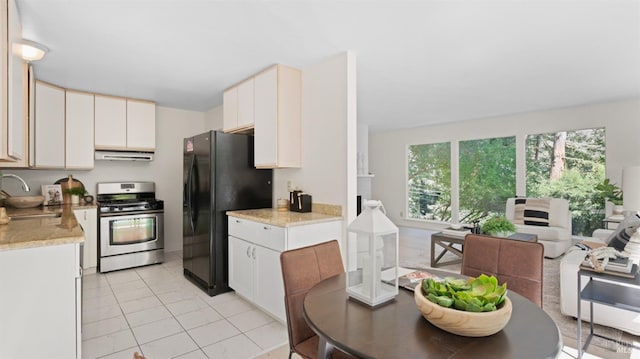 317 Olema Rd, Fairfax, CA 94930 - kitchen with stainless steel gas stove, freestanding refrigerator, exhaust hood, a sink, and light countertops
