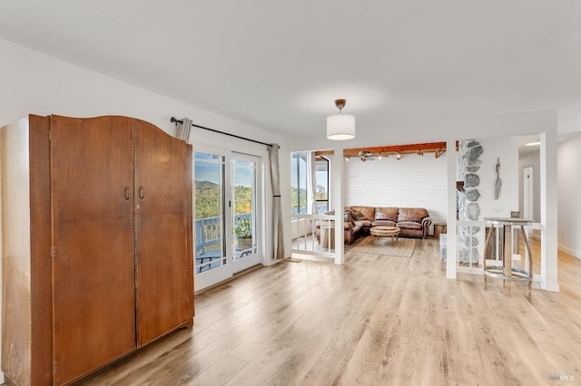 living area with light wood-style floors and baseboards