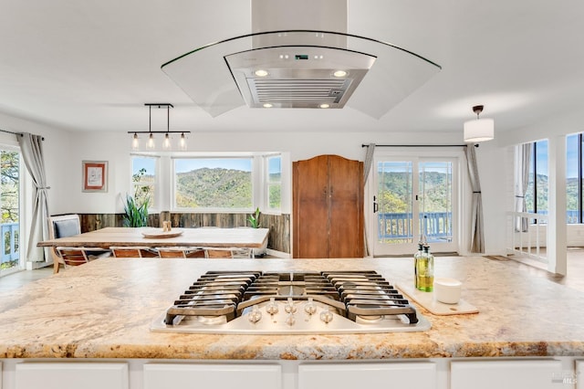 kitchen featuring a wealth of natural light, white cabinetry, and stainless steel gas cooktop