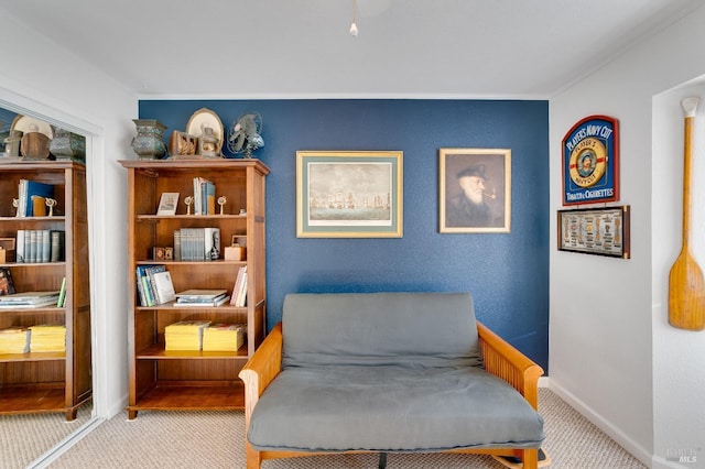 living area featuring carpet floors and baseboards