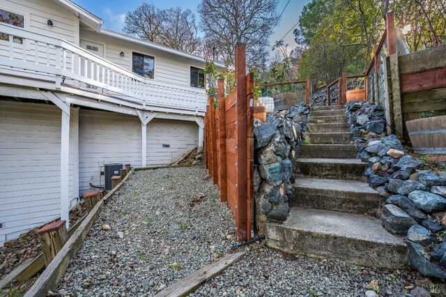 view of yard featuring central air condition unit and stairs