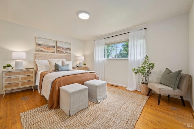 bedroom featuring light wood-style flooring and visible vents