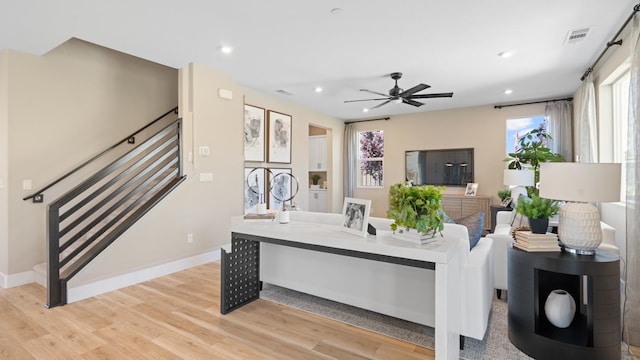 1096 Fiano Pl, Manteca, CA 95337 - living room with stairs, light wood-style floors, a ceiling fan, recessed lighting, and baseboards