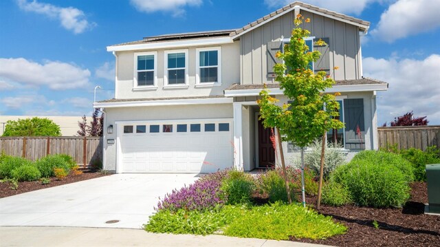 1096 Fiano Pl, Manteca, CA 95337 - traditional-style house with fence, an attached garage, roof mounted solar panels, and driveway