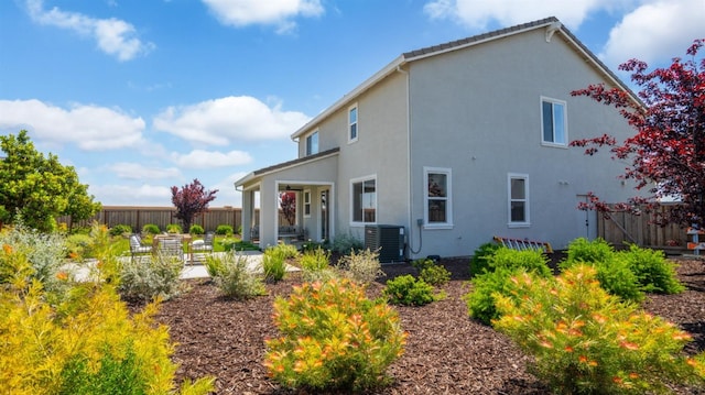 1096 Fiano Pl, Manteca, CA 95337 - back of house featuring central AC, fence, stucco siding, and a patio area