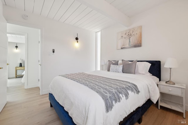 bedroom with baseboards, wood finished floors, beam ceiling, and wood ceiling