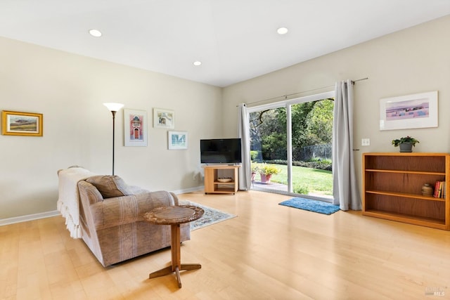 living room featuring recessed lighting, light wood-style flooring, and baseboards