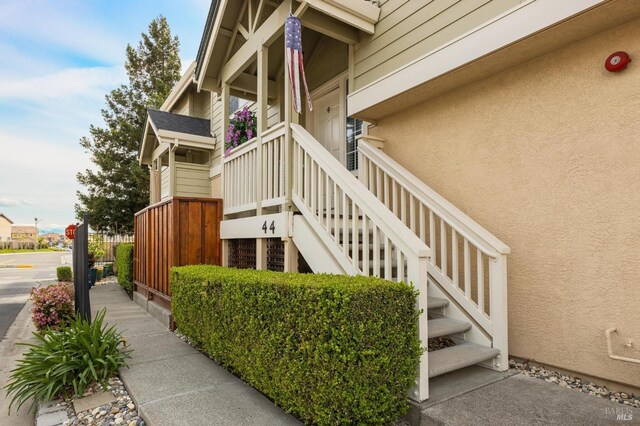 view of property exterior featuring stairs and stucco siding