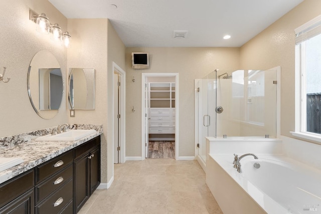 8568 Pinehollow Cir, Discovery Bay, CA 94505 - bathroom featuring a shower stall, a spacious closet, a garden tub, double vanity, and baseboards
