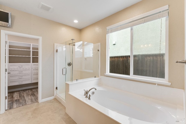 8568 Pinehollow Cir, Discovery Bay, CA 94505 - bathroom featuring a shower stall, a garden tub, and a walk in closet